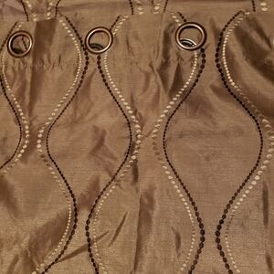 BROWN and cream stitching on tan drapes.